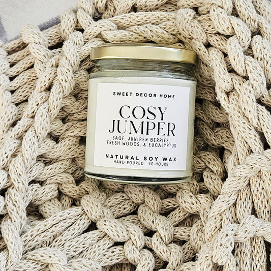Candle labeled 'Cosy Jumper' 190ml clear glass jar with white label and black font