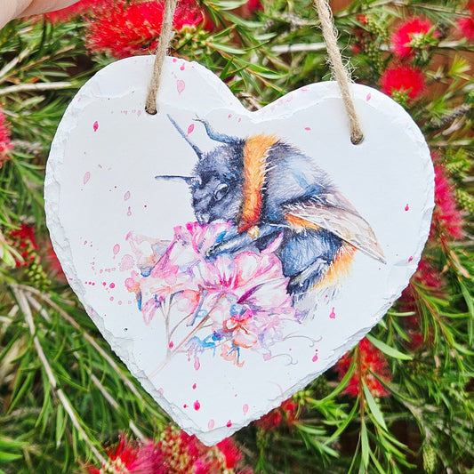 Heart-shaped hanging decor with a bee and floral design by meg Hawkins