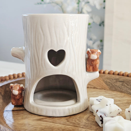 White ceramic tree shaped wax warmer  with heart and highland cow figurines design on side