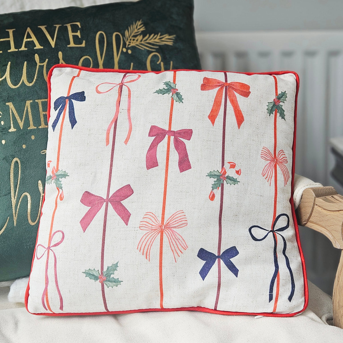 Merry Little Bows square Christmas cushion with repeating bow print