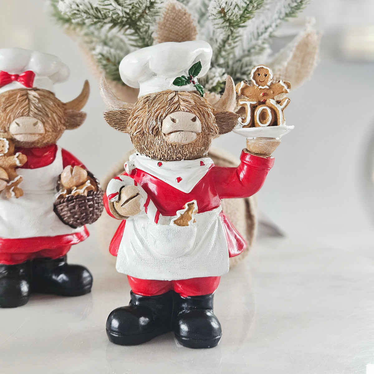 highland cow chef with holly hat and gingerbread and joy tray