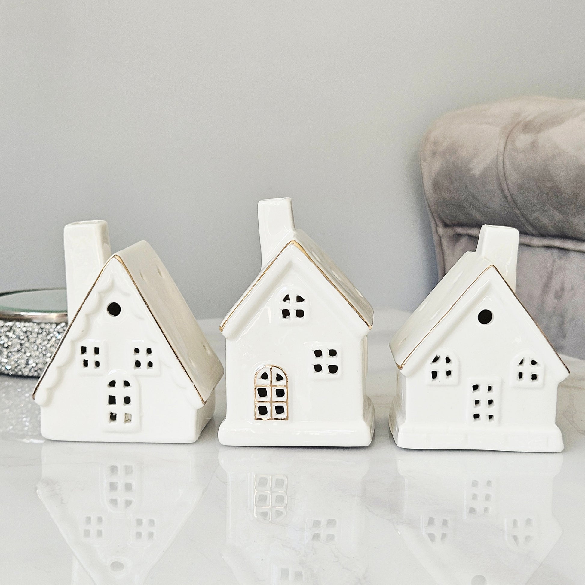Three white ceramic house-shaped led lanterns christmas