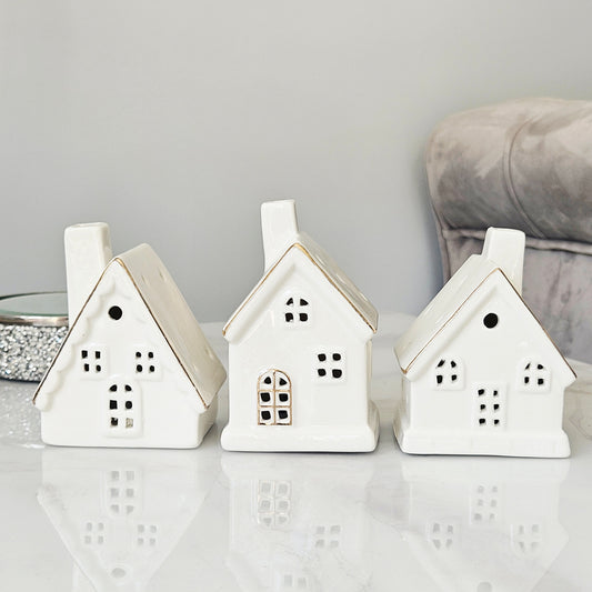 Three white ceramic house-shaped led lanterns christmas
