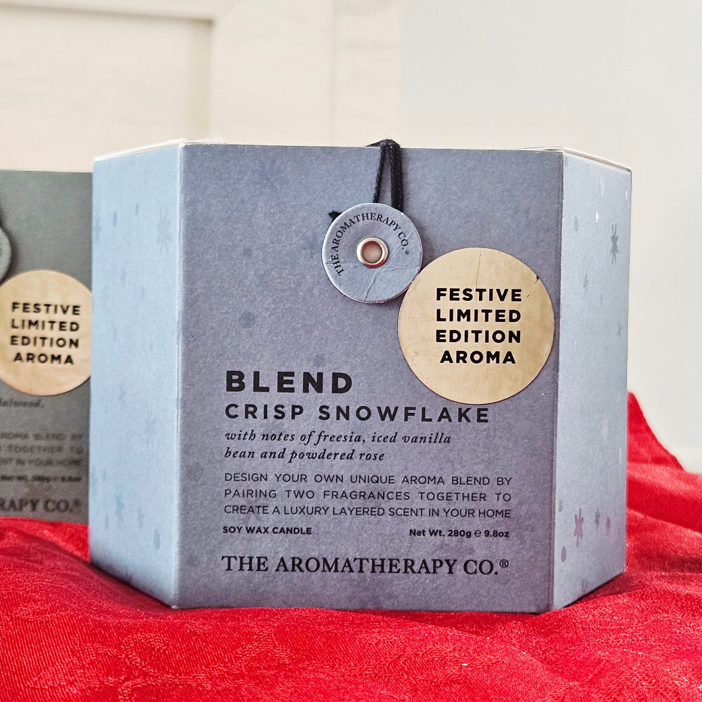 Candle packaging with 'Festive Limited Edition Aroma' label snowflake aromatherapy co blend