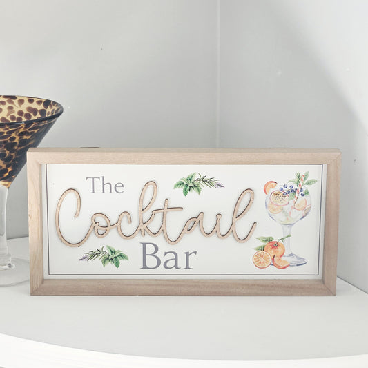 Decorative wooden framed sign with 'The Cocktail Bar' text and cocktail illustrations on a white background.