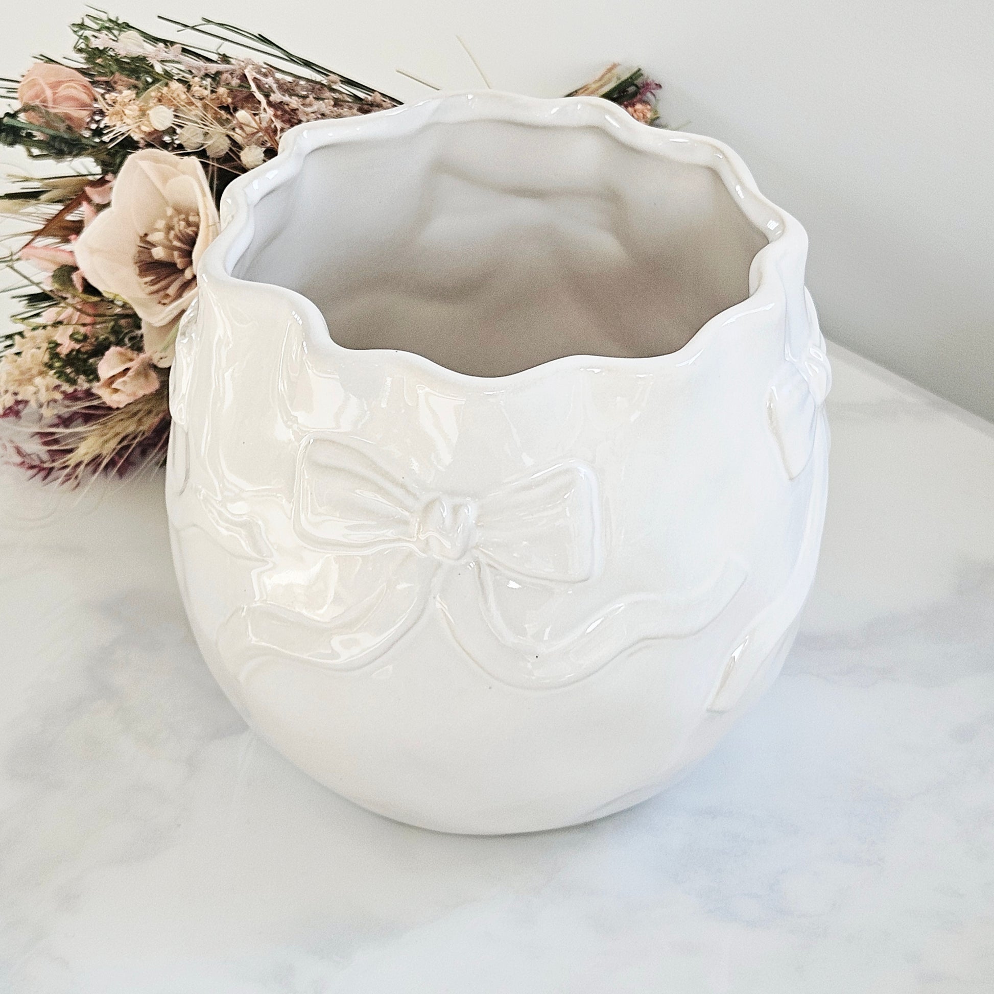 White ceramic vase with decorative bows all around it large in size 