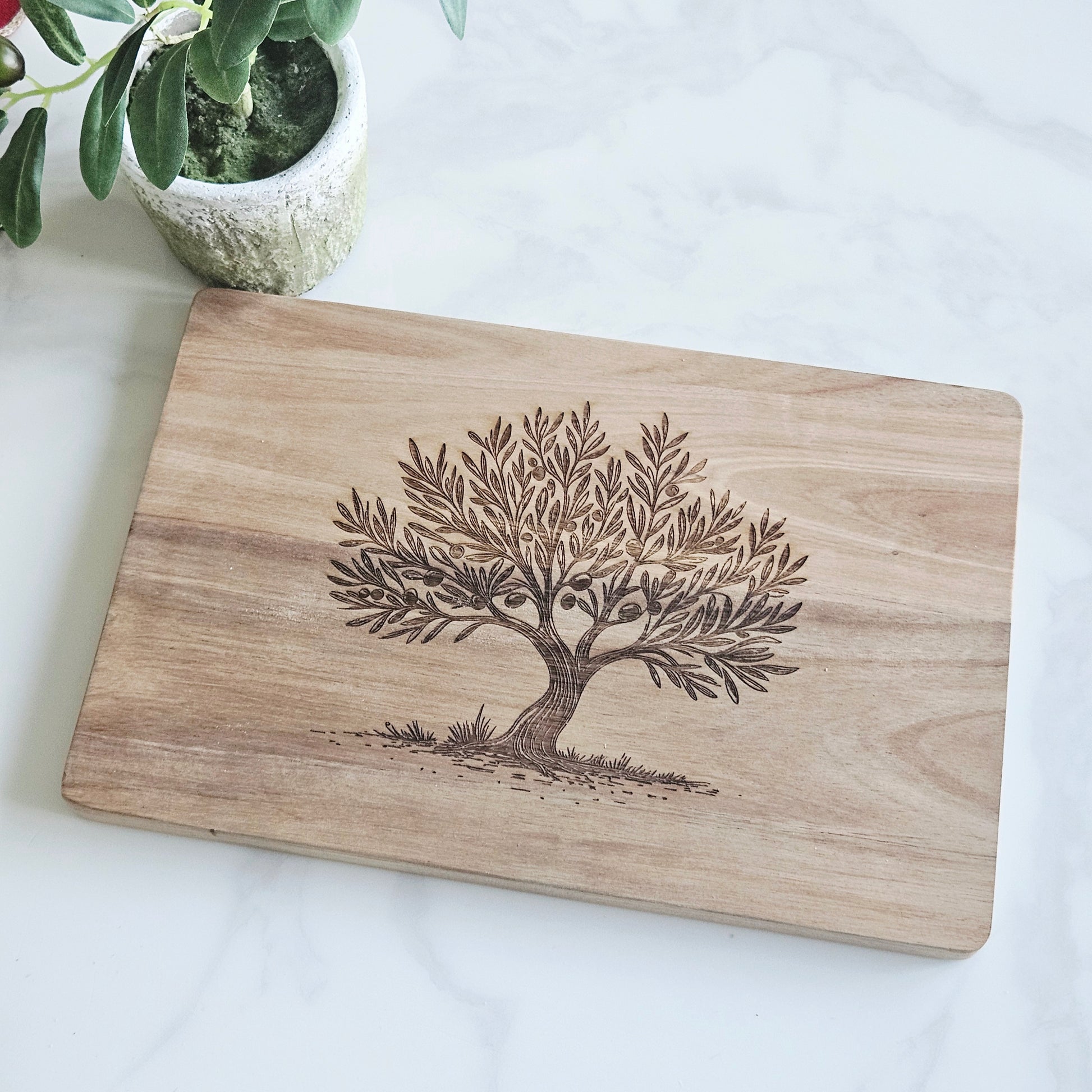 Wooden acacia servinpg board with olive tree engraving on the front
