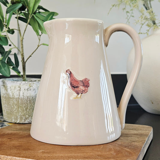 Beige stoneware jug pitcher with a chicken design
