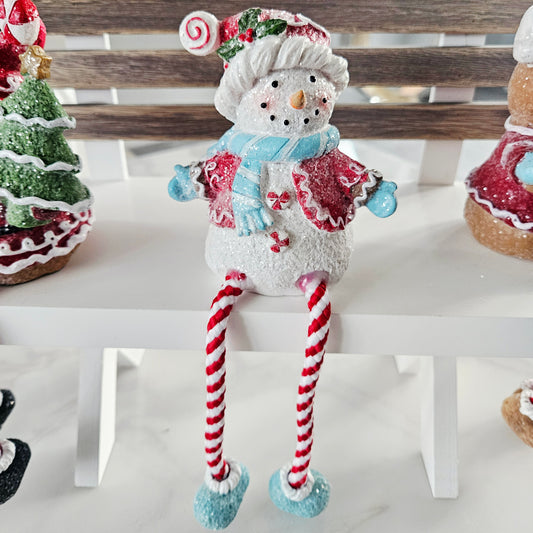 Decorative snowman figurine with candy cane legs 