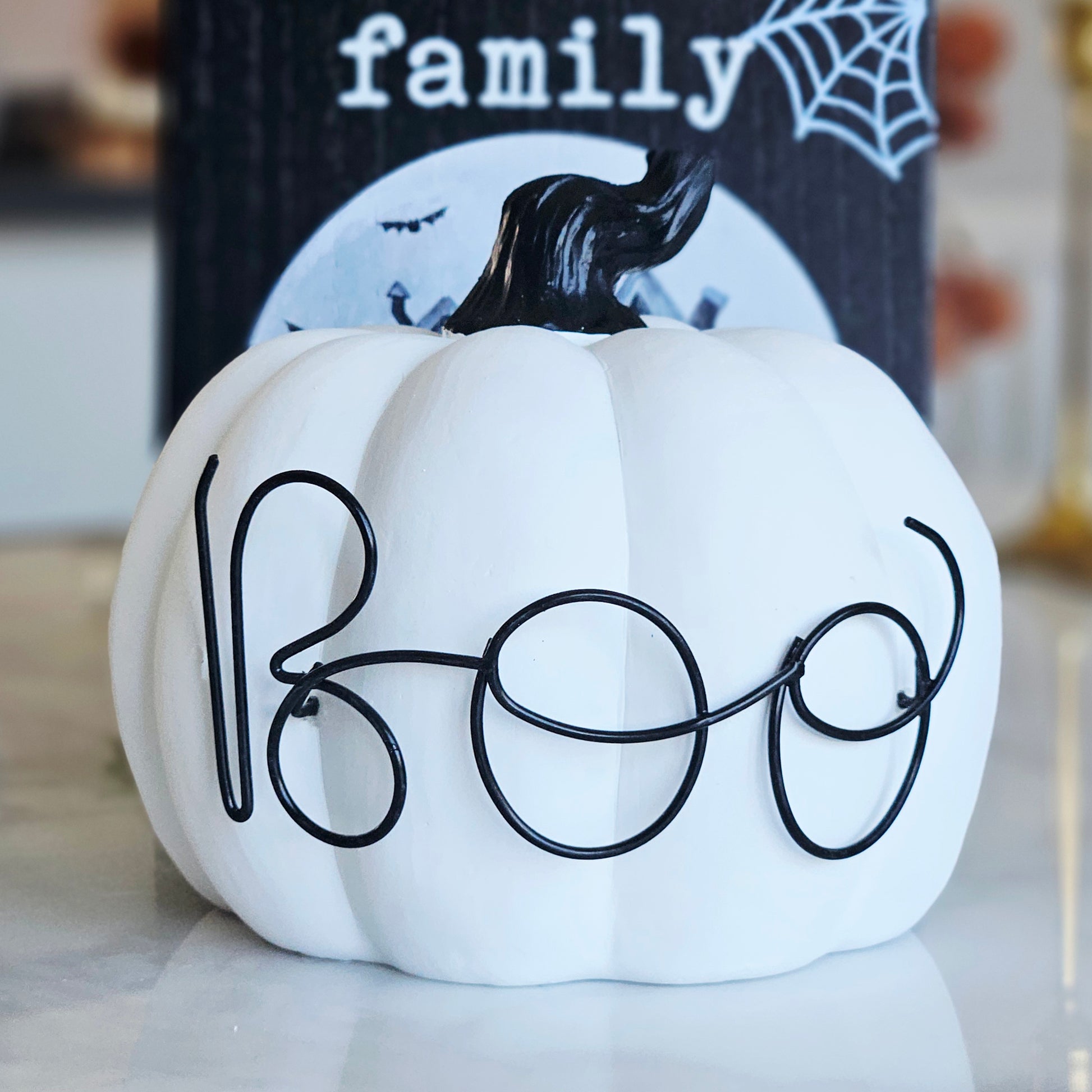 Black & White Boo Pumpkin Ornament for Halloween home décor displayed on a shelf as a stylish seasonal decoration