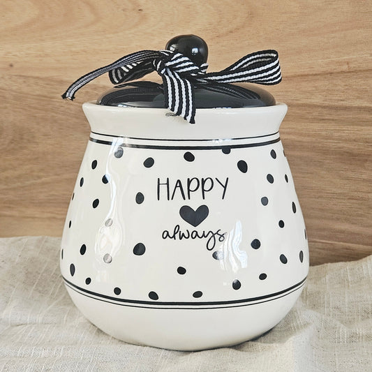 White ceramic jar with black polka dots and text, tied with a black and white striped ribbon, happy always text
