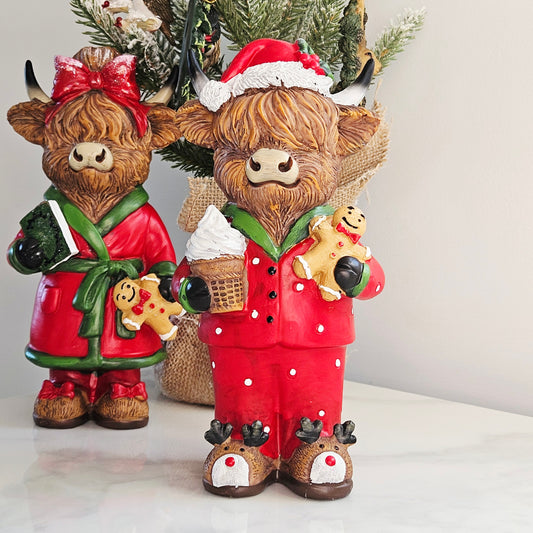 Mr Christmas Highland cow figurine wearing red Christmas pyjamas and Santa hat