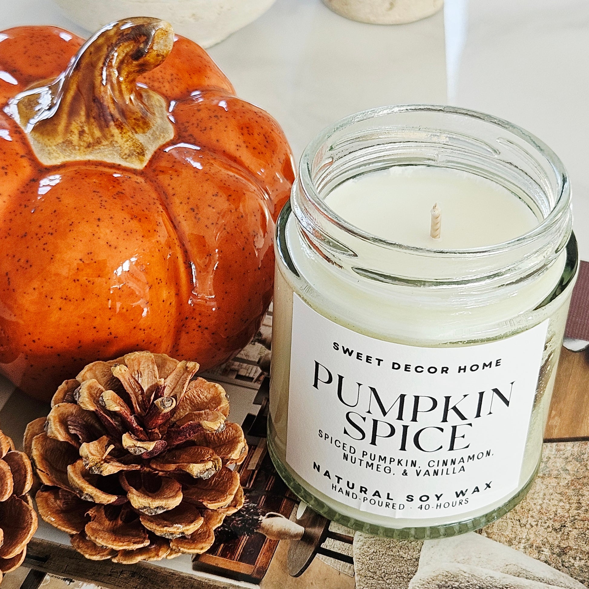 Pumpkin spice scented candle with a white label and black font by sweet decor home, 40hrs burn 190ml natural soy wax