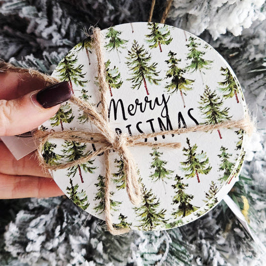 Set of four round coasters with Christmas tree pattern and 'Merry Christmas' text, tied with twine