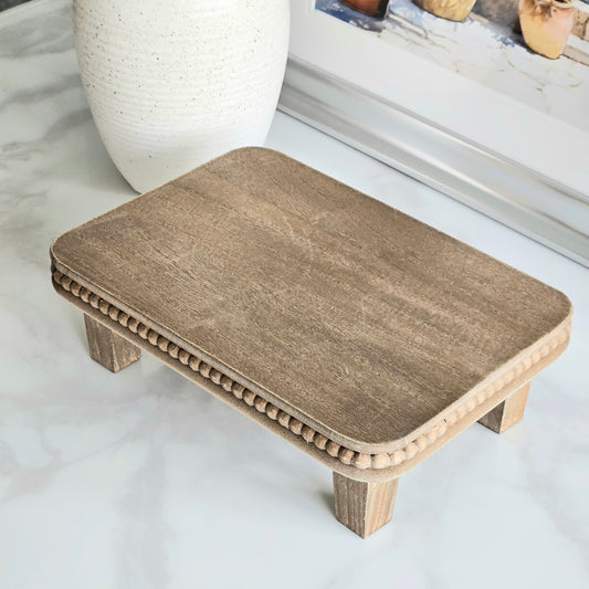 Natural wood beaded riser tray for styling