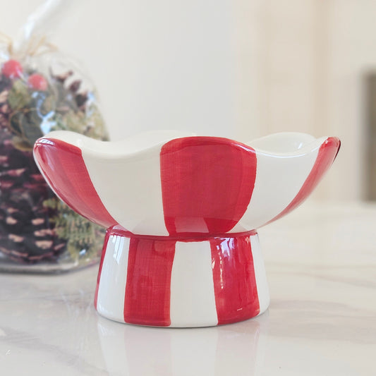 A small ceramic pedestal dish with a scalloped rim, decorated in a red and white striped pattern, Red and white striped Christmas candy bowl 15cm
