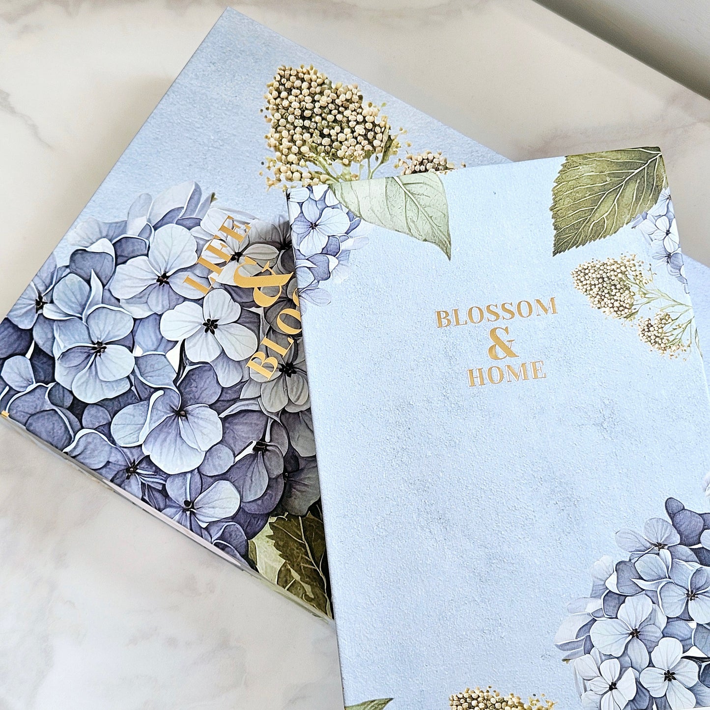 set of 2 Hydrangea storage boxes in a blue and green floral display 