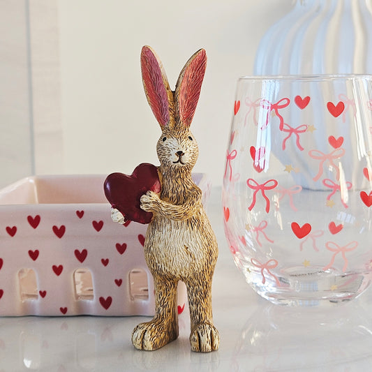 Decorative rabbit figurine holding a red heart,