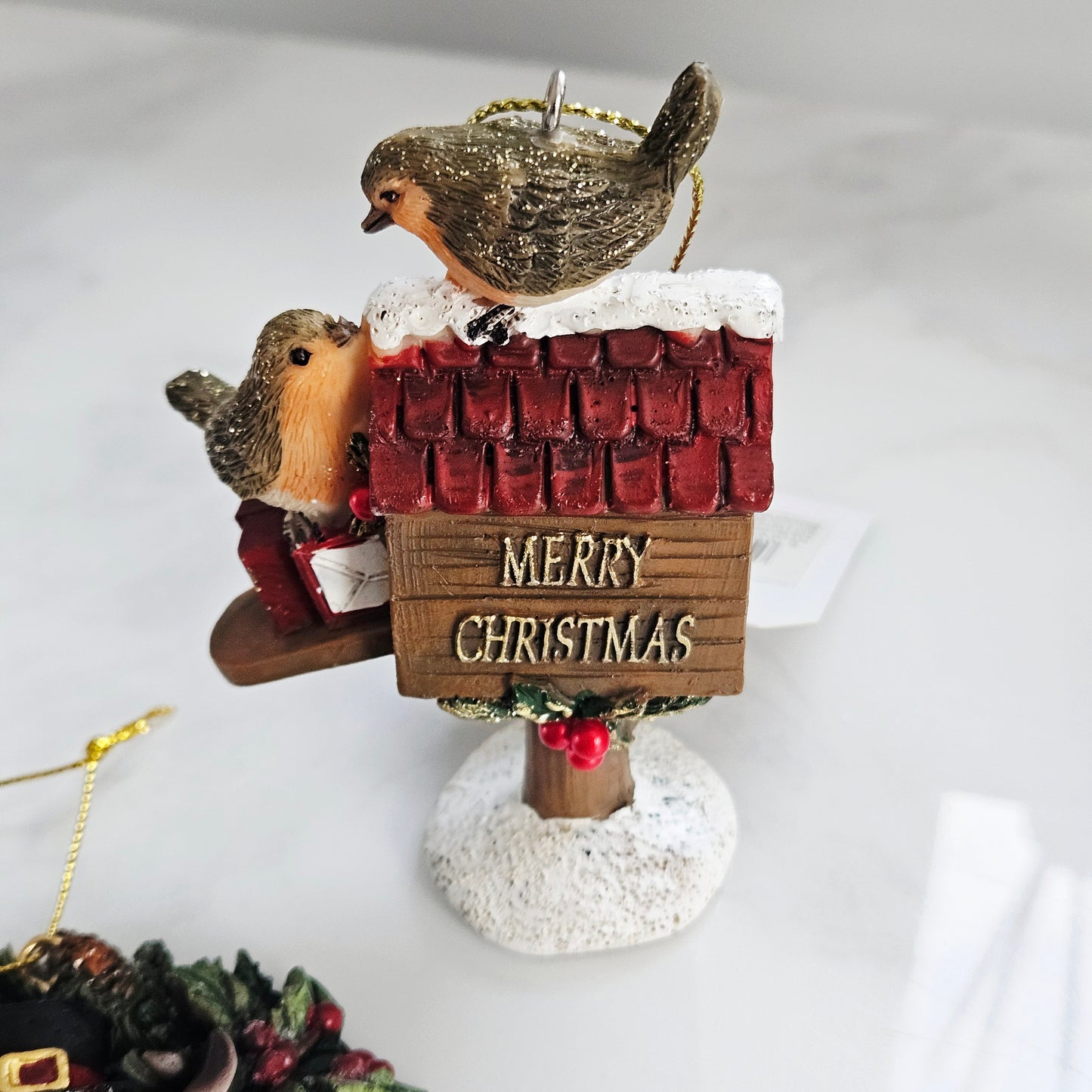 Decorative ornament with two robin birds on a 'Merry Christmas' mailbox