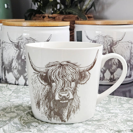 White conical ceramic mug with black illustrated Highland cow design
