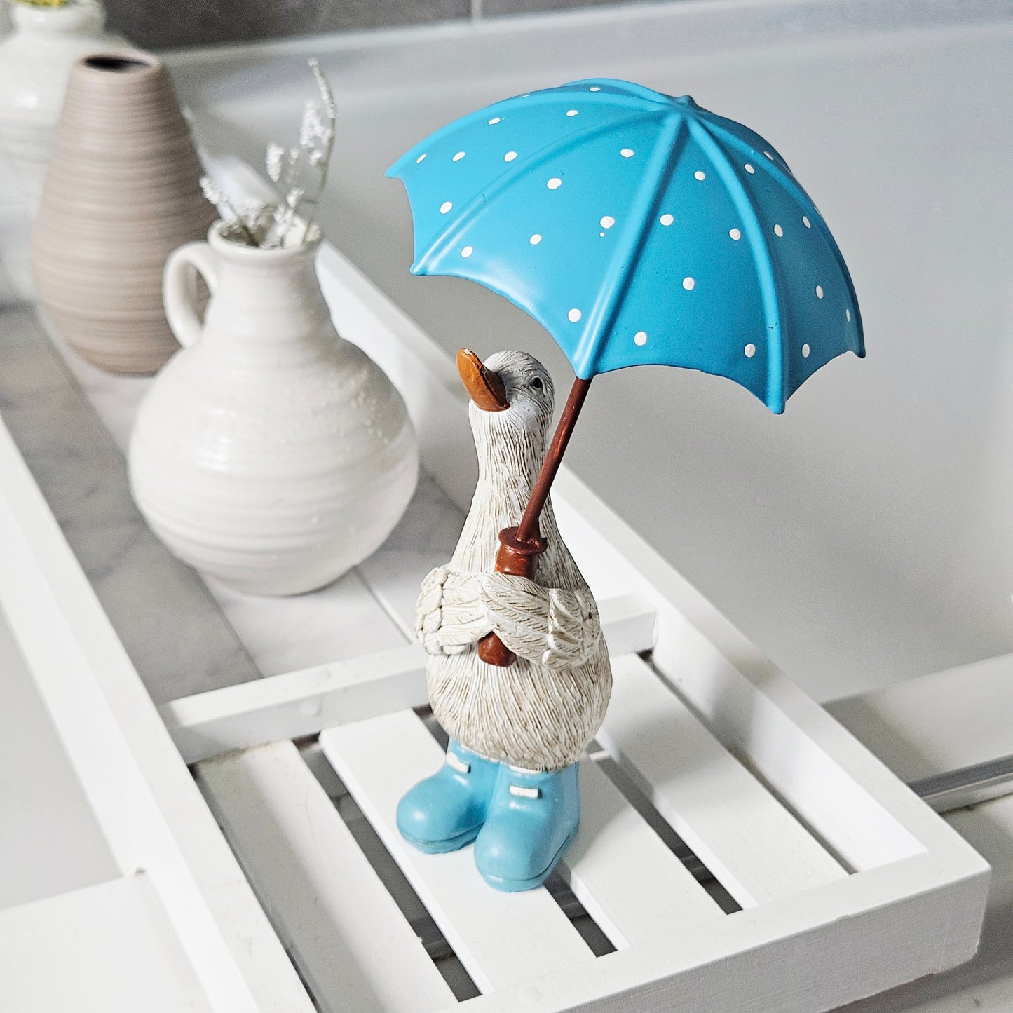 Duck Holding Blue Spotty Umbrella