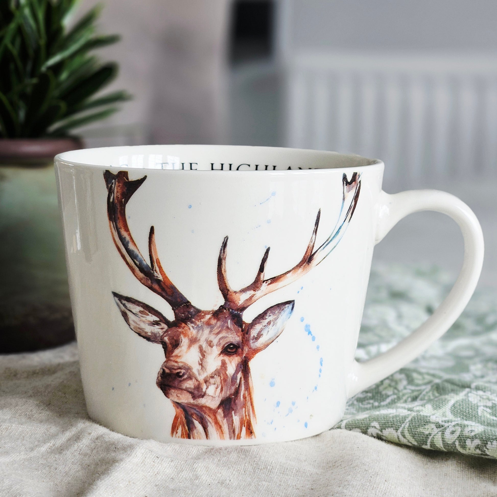 stag mug by meg hawkins with the highland stag written inside 