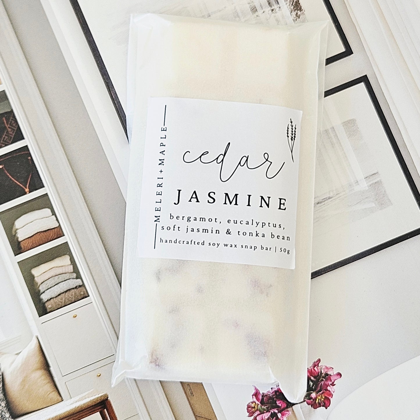 Packaged wax melt snap bar labeled 'cedar jasmine' next to an unwrapped soap bar with visible ingredients.