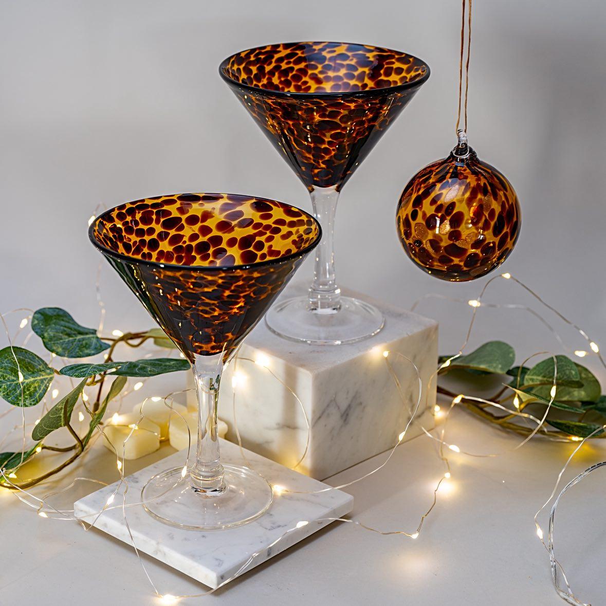 Two leopard print martini glasses on with a matching glass bauble ornament