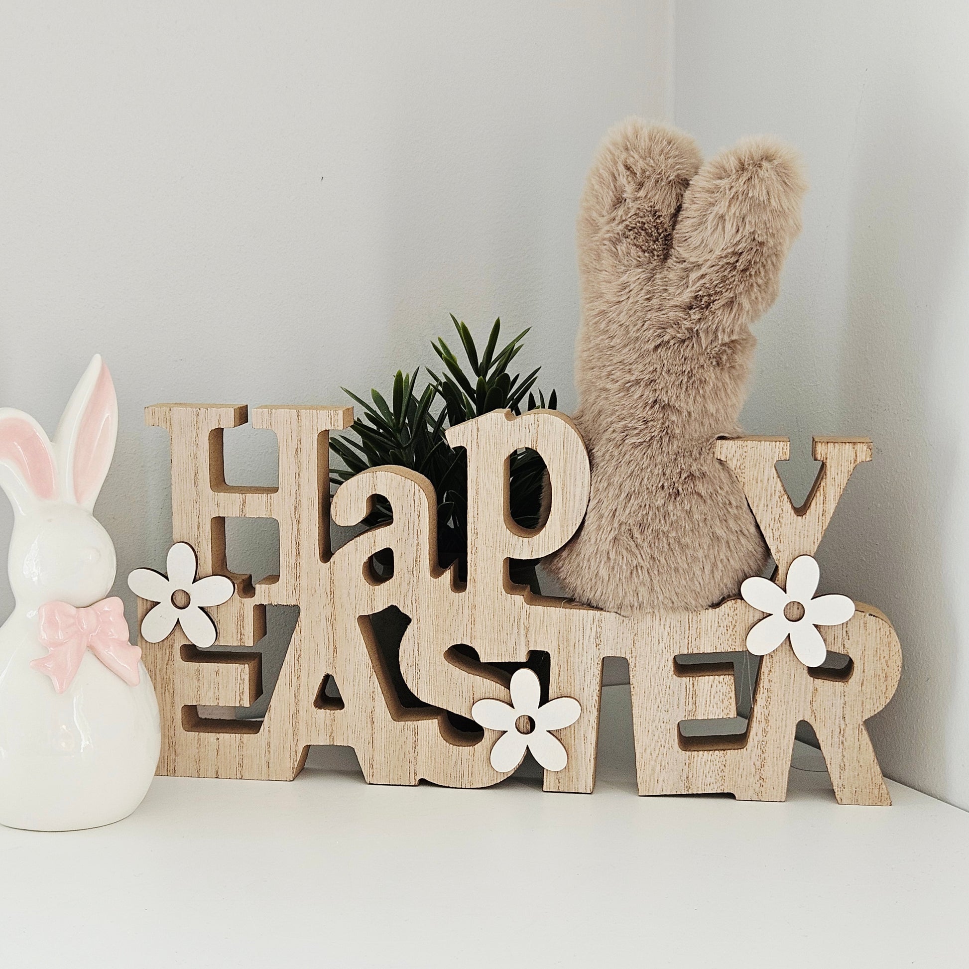 Decorative sign with 'Happy Easter' text and a fluffy bunny tail 