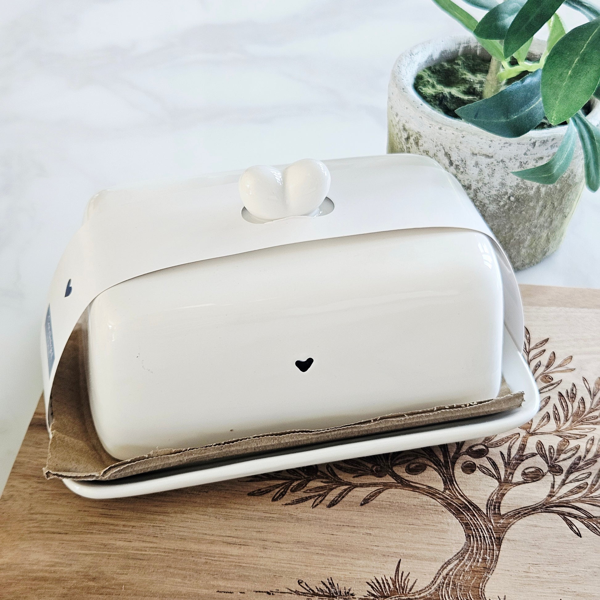 white ceramic butter dish with navy blue heart and heart lid