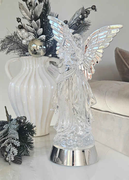 A clear acrylic angel led light up figurine with iridescent wings and a silver base, 