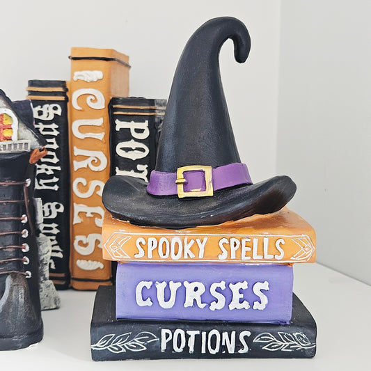 Halloween-themed decoration with a witch hat and books 