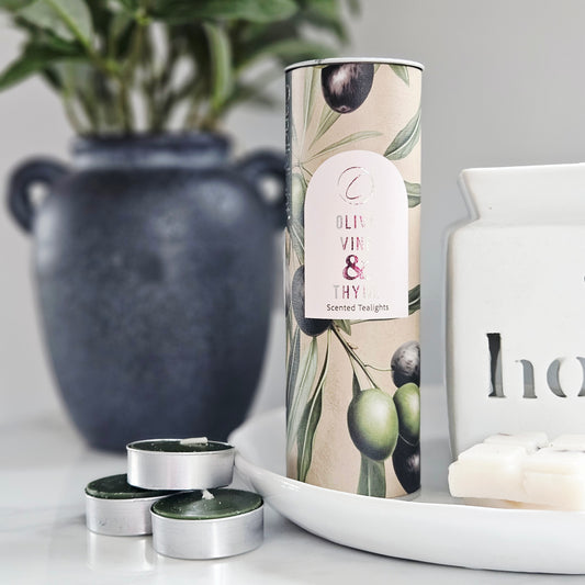 Olive oil and thyme scented tealight packaging tube with candles tea lights on green
