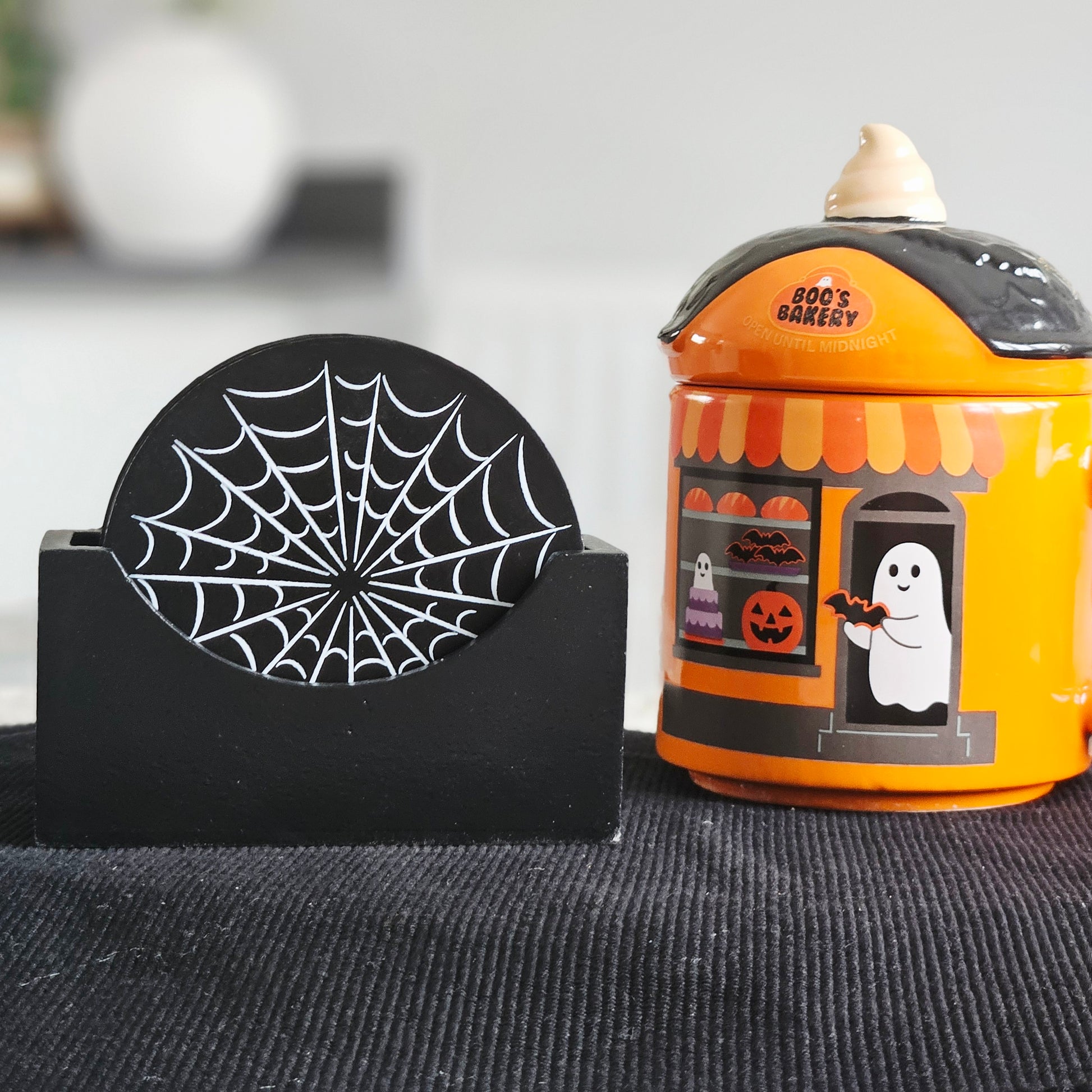 set of 4 Black coaster set with spider web design in a black holder 