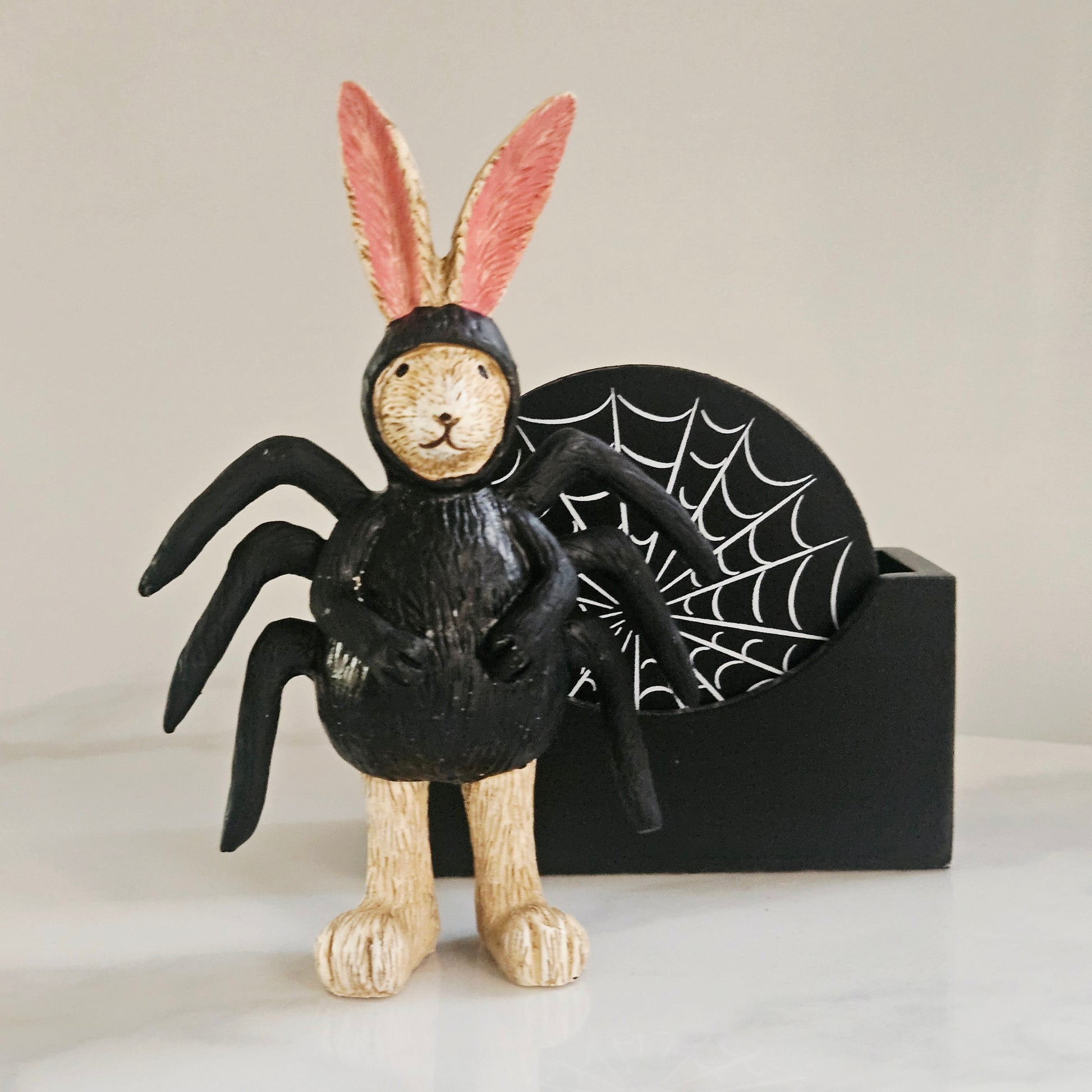 A Halloween decorative figurine of a rabbit dressed as a spider