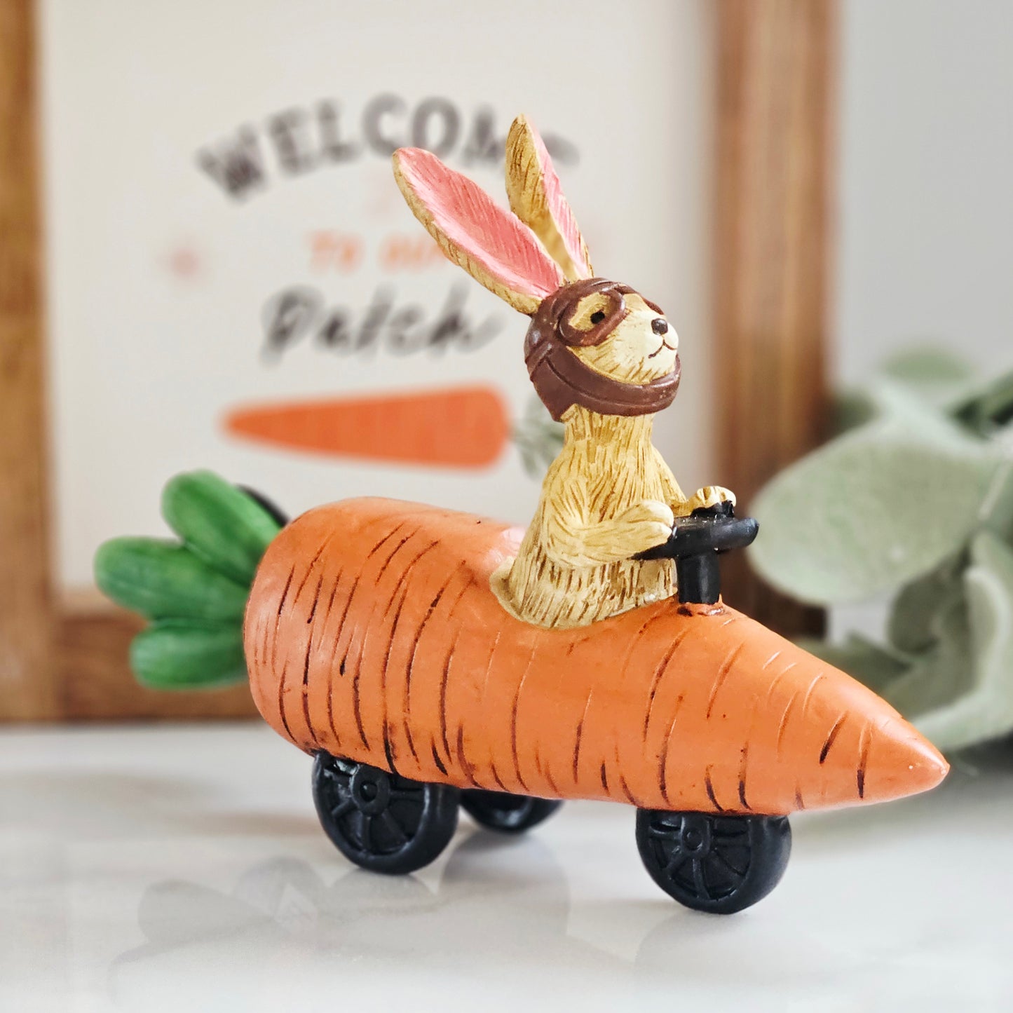 jasper rabbit figurine ornament sitting in a carrot racing car