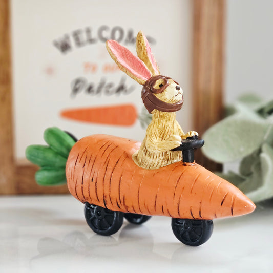 jasper rabbit figurine ornament sitting in a carrot racing car