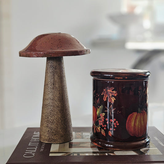 A rustic mushroom-shaped mango wood mushroom standing with terracotta and orange tones