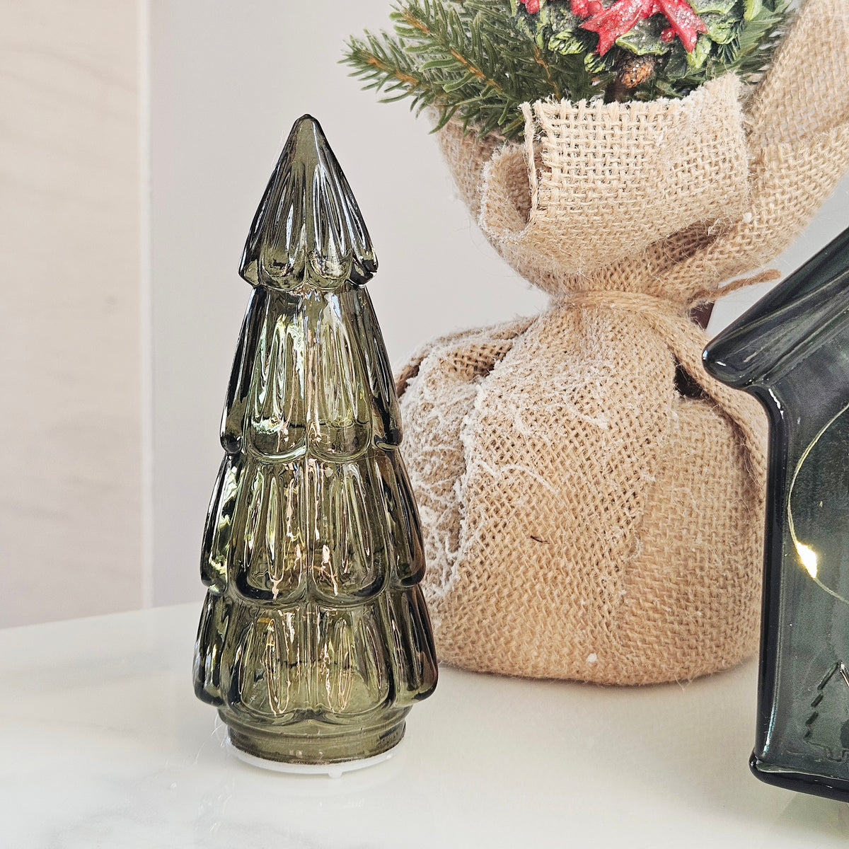 A small ribbed glass led  Christmas tree r in a smoky olive green colour