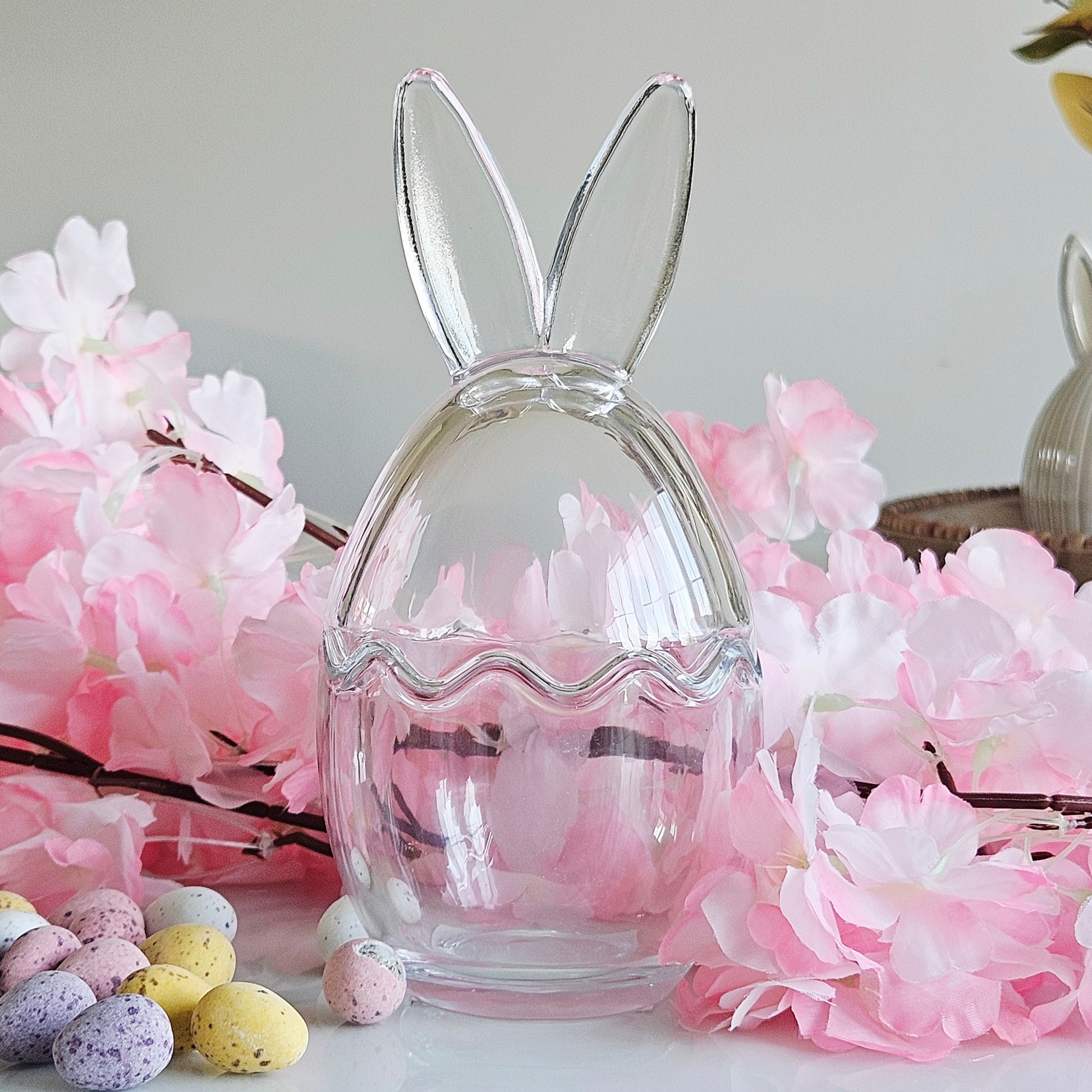 Clear glass bunny-shaped egg holder with bunny ears storage treats