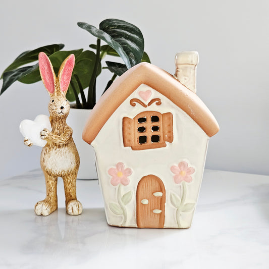 Ceramic tea light fairy shaped house with pastel tones and daisies