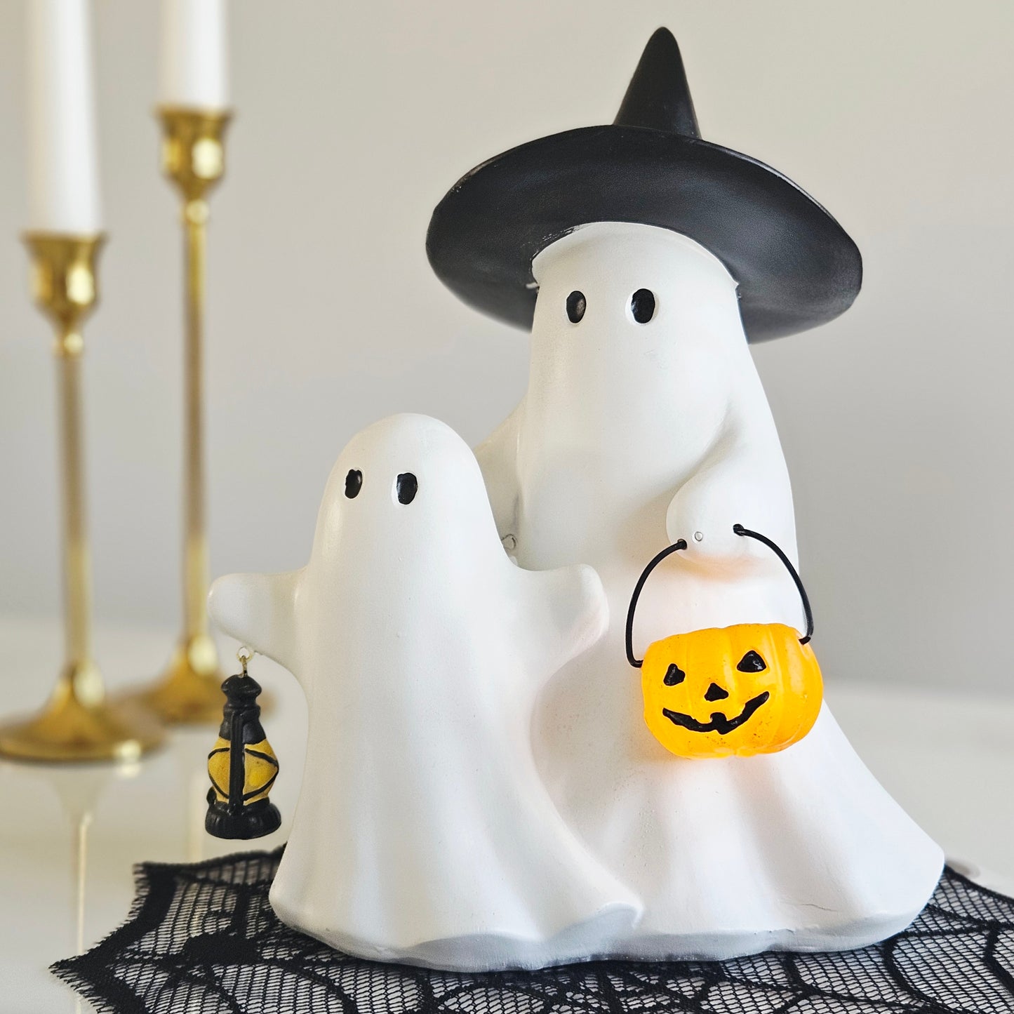 Resin ghosts holding a light up lantern Halloween LED decoration for spooky seasonal home décor