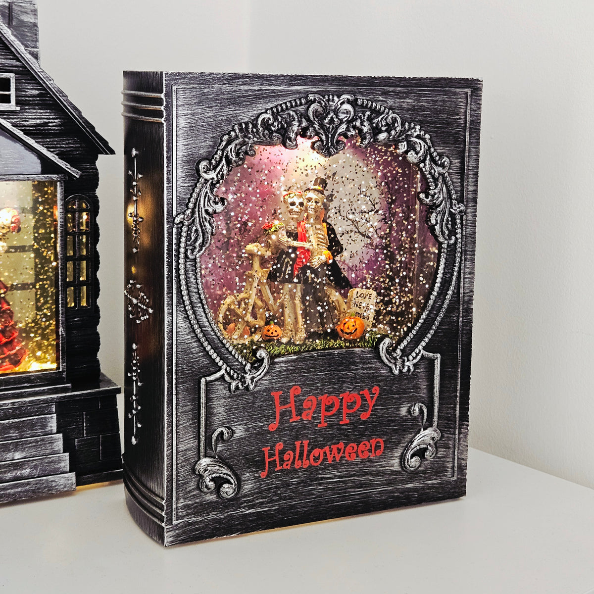 16x20cm Halloween book spinner with smiling skeletons and spinning glitter effect