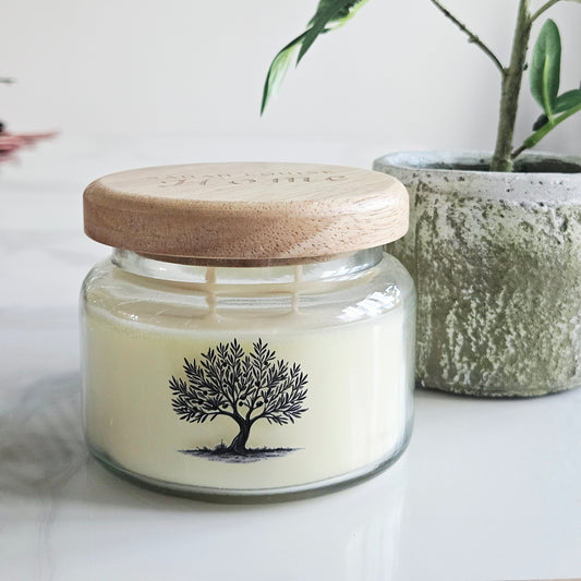 Candle in a glass jar with a wooden lid, featuring an olive tree design