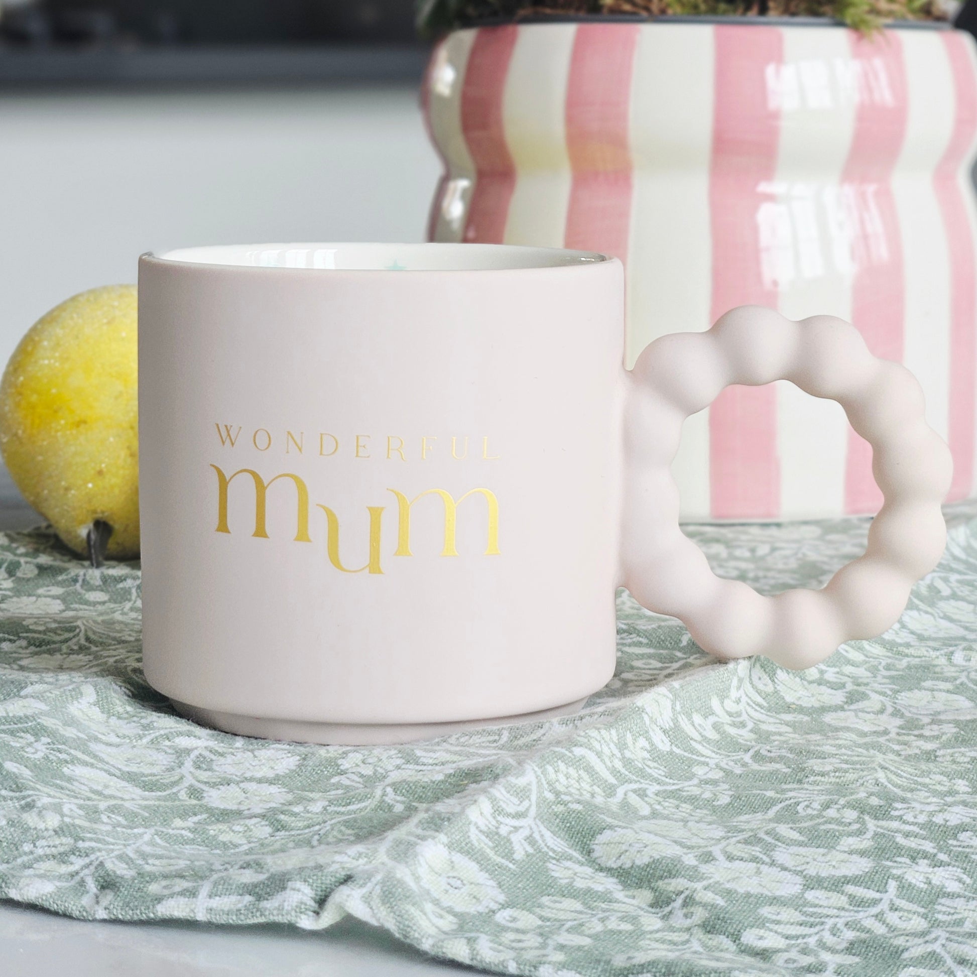 White mug with 'Wonderful mum' text and multi coloured stars inside with confetti design and bobble handle