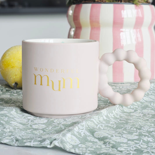 White mug with 'Wonderful mum' text and multi coloured stars inside with confetti design and bobble handle