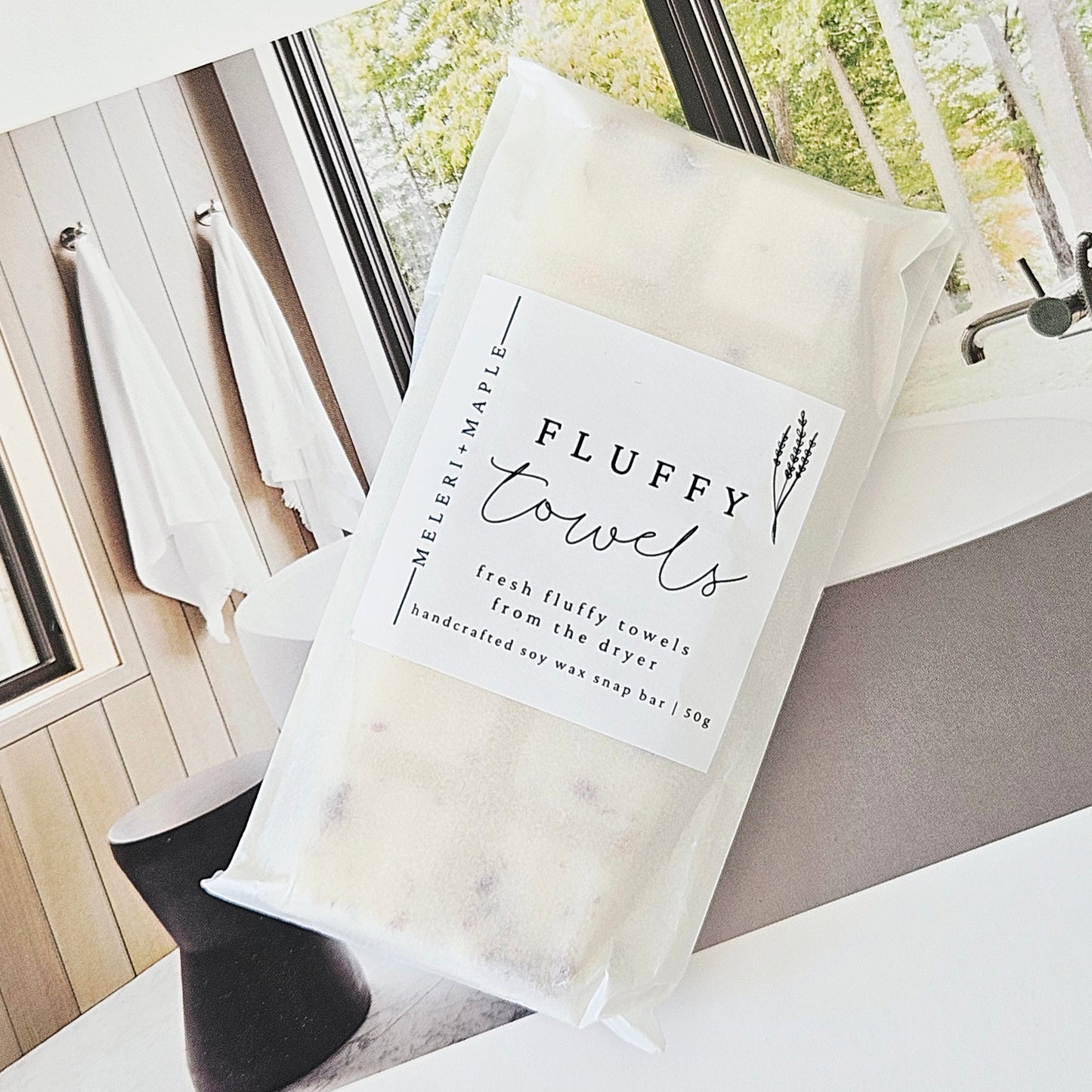 Soy wax melts snap bar with packaging labeled 'Fluffy Towels' on a white background