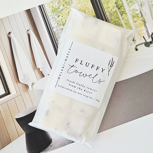 Soy wax melts snap bar with packaging labeled 'Fluffy Towels' on a white background