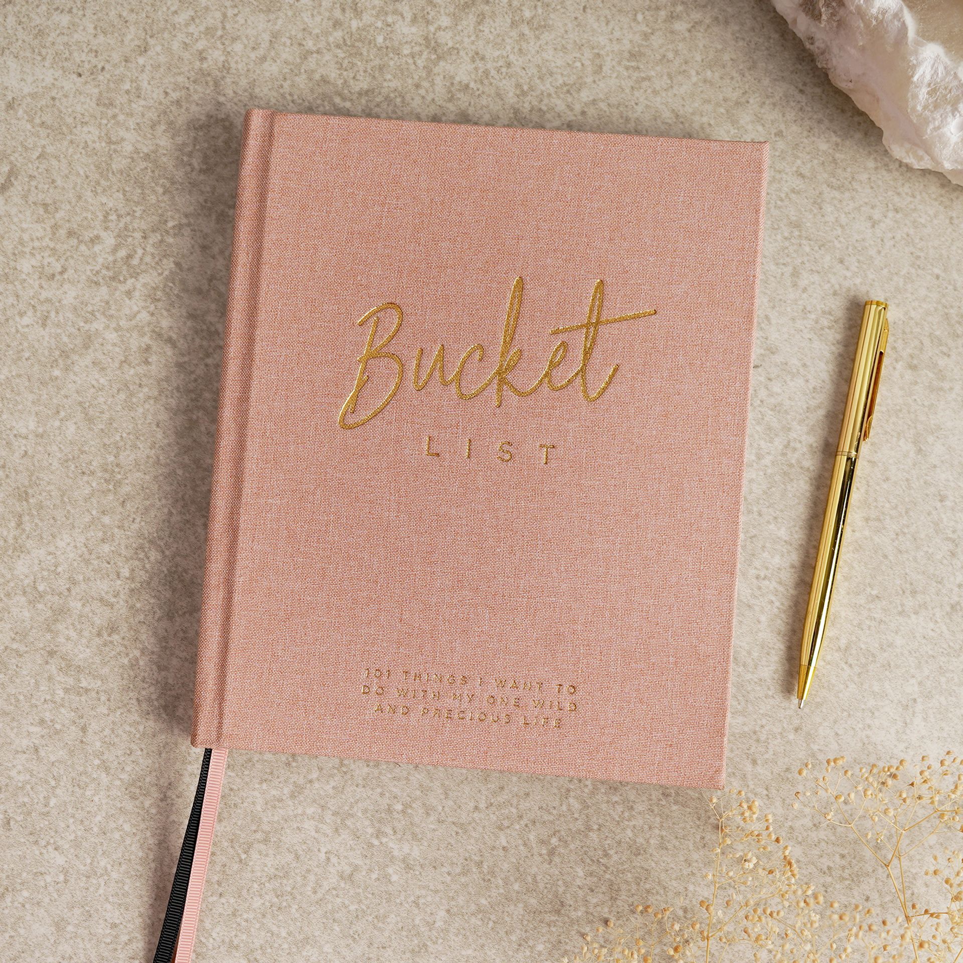 Pink notebook titled 'Bucket List' with a gold pen by serenity 