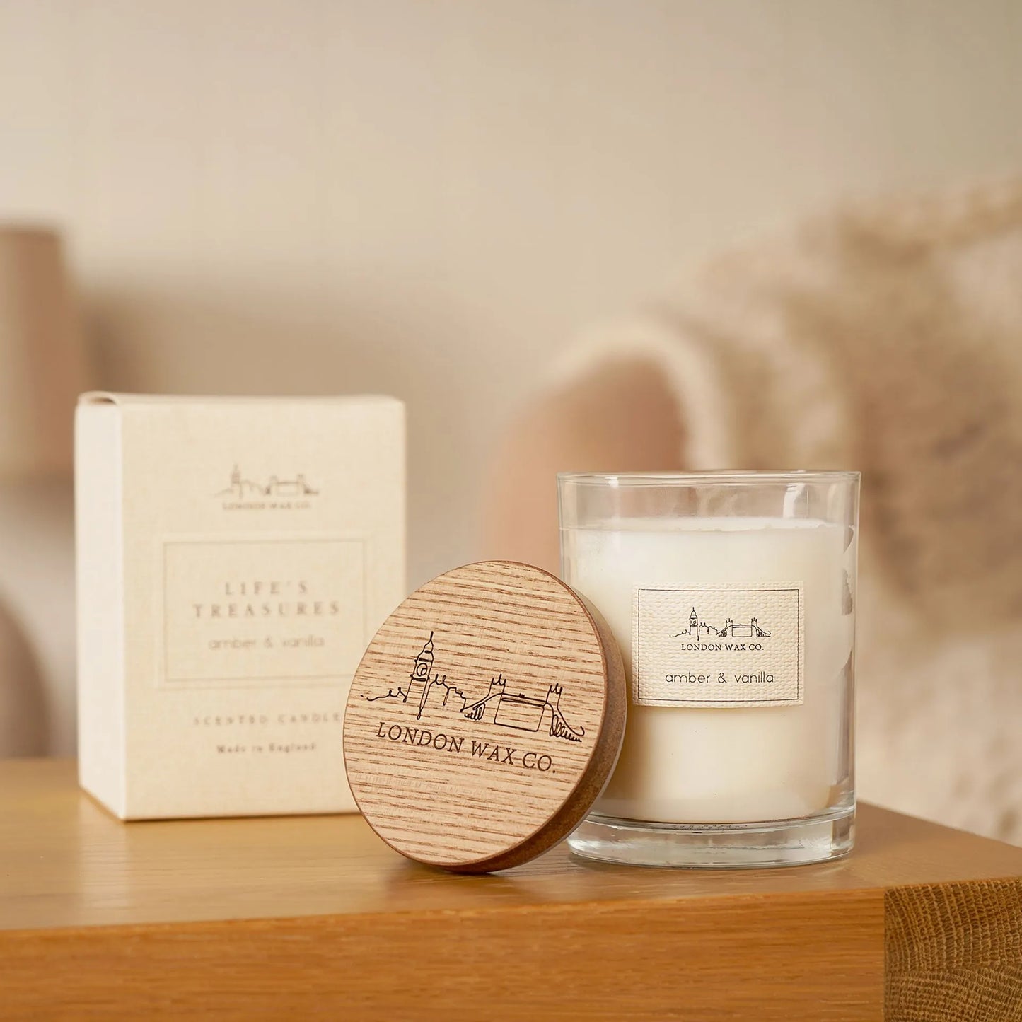 Candle and packaging with 'London Wax Co.' branding on wooden lid amber and vanilla